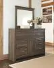 Ashley Furniture B251/31/36/46/58/56/94 Ashley Furniture B251/31/36/46/58/56/94 Juararo - 6 Pc. - Dresser, Mirror, Chest, California King Panel Bed - Dark Brown