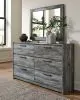 Ashley Furniture B221/31/35/56S/58/60/95/B100-14/91(2) Ashley Furniture B221/31/35/56S/58/60/95/B100-14/91(2) Baystorm - King Panel Bed With 4 Storage Drawers - 9 Pc. - Dresser, Mirror, King Bed, 2 Nightstands - Gray